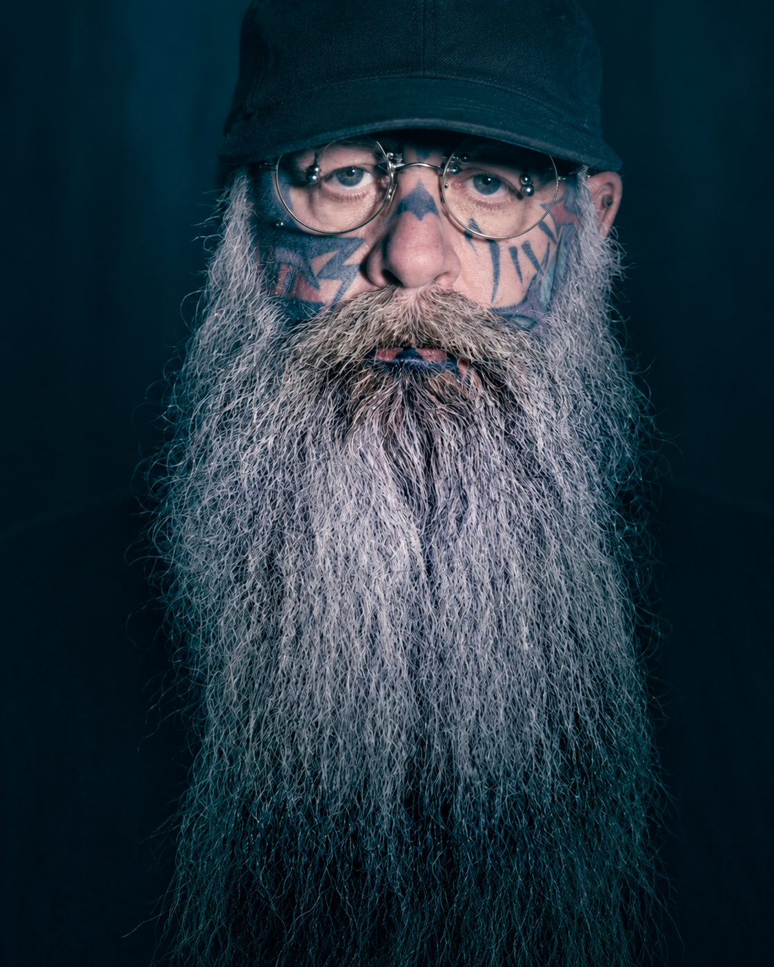 The Scary Guy wearing a black hat and glasses